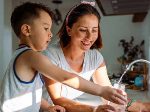 mom and child washing hands together